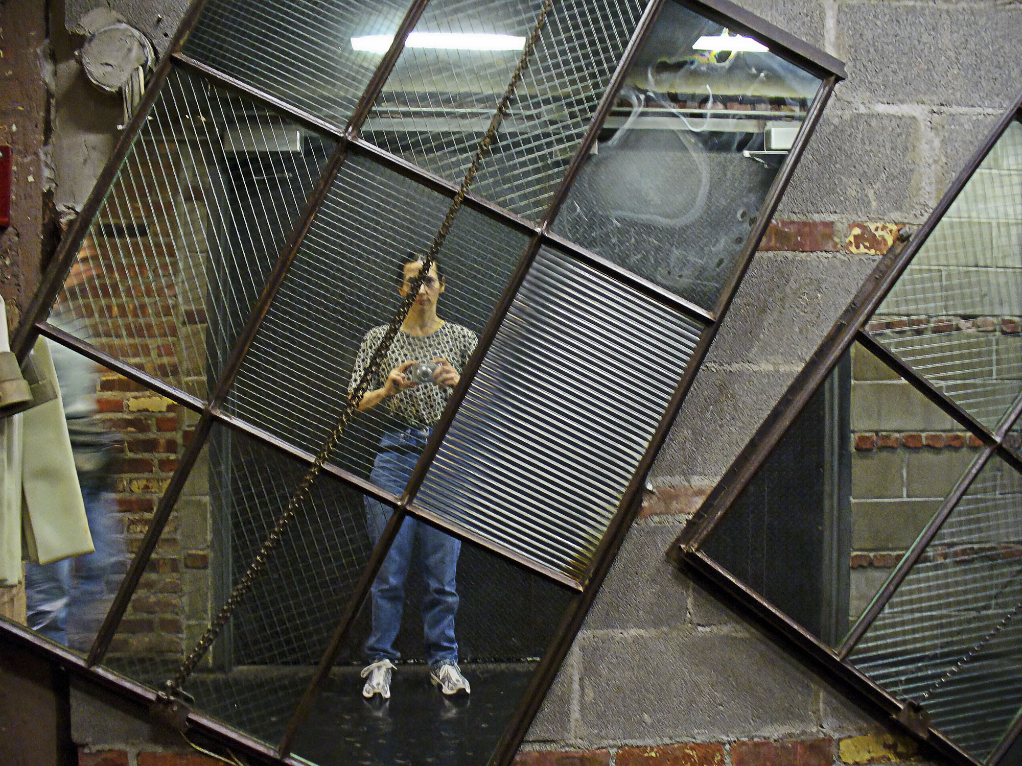 person reflected in mirror exhibit, subway in NYC