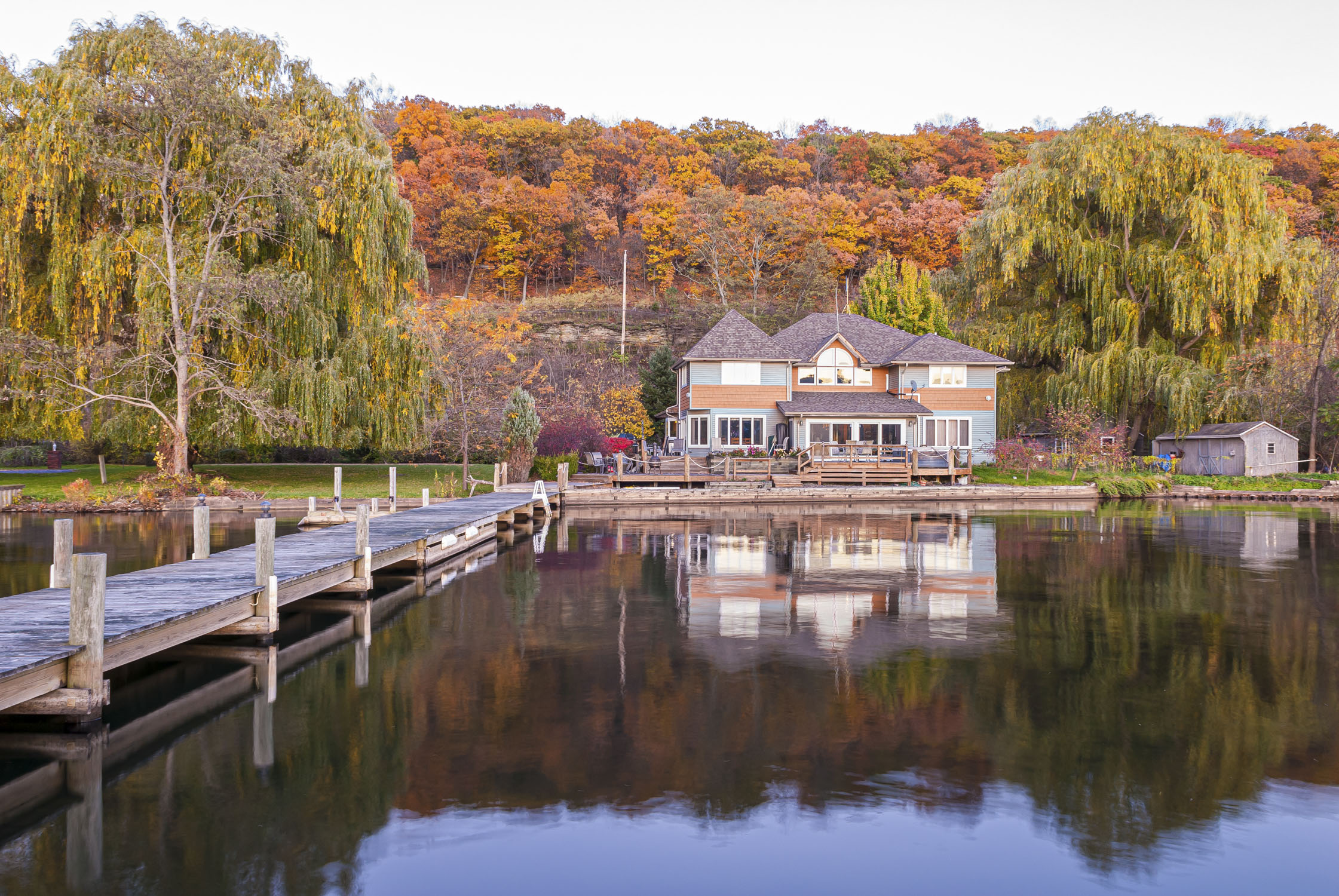 A house and pier with autumn leaves. Finger Lakes, New York