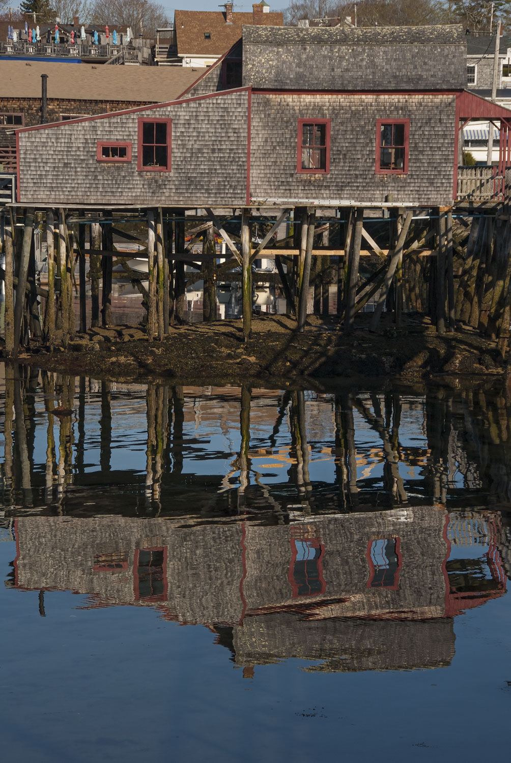 The Pier House reflected in the water in Boothbay Harbor, Maine