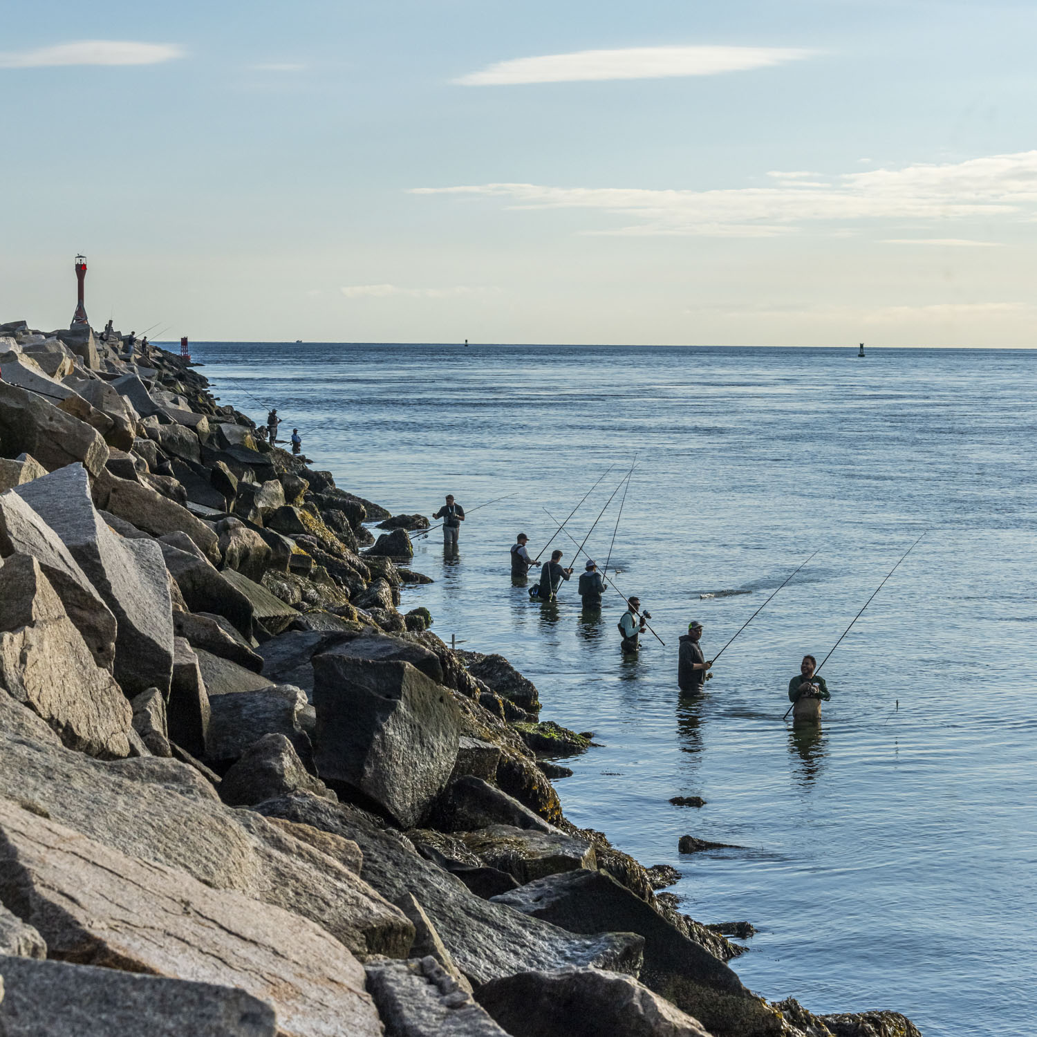 Fisherman in a lined up at Scusset Beach and Cape Cod Canal