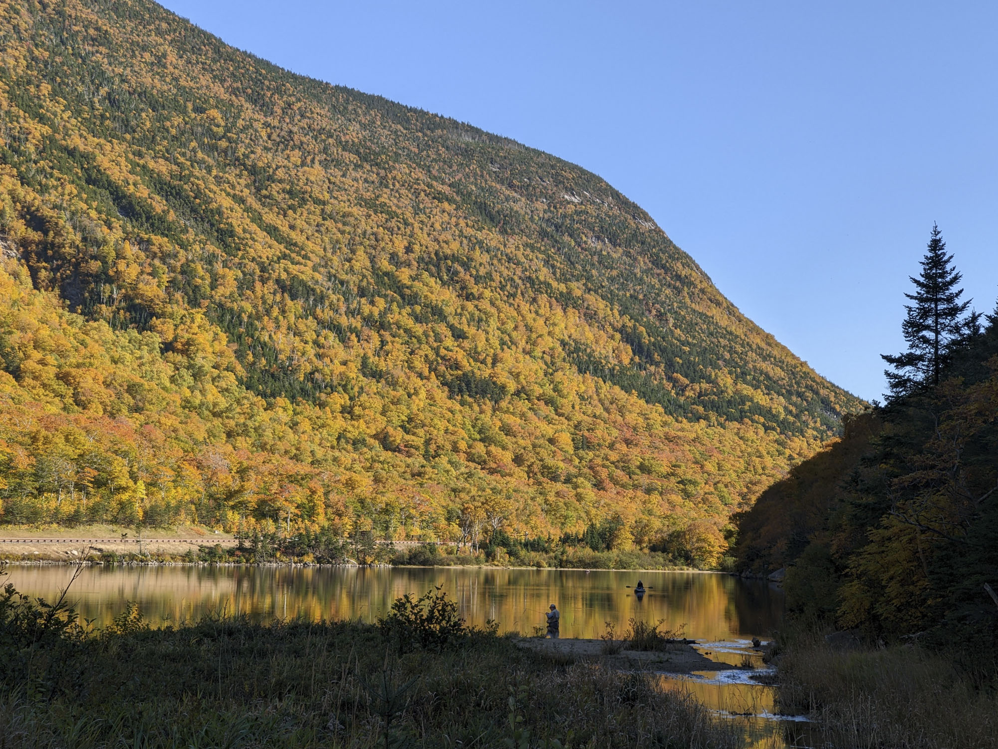 Autumn scene of a fisherman on a lake in New Hampshire