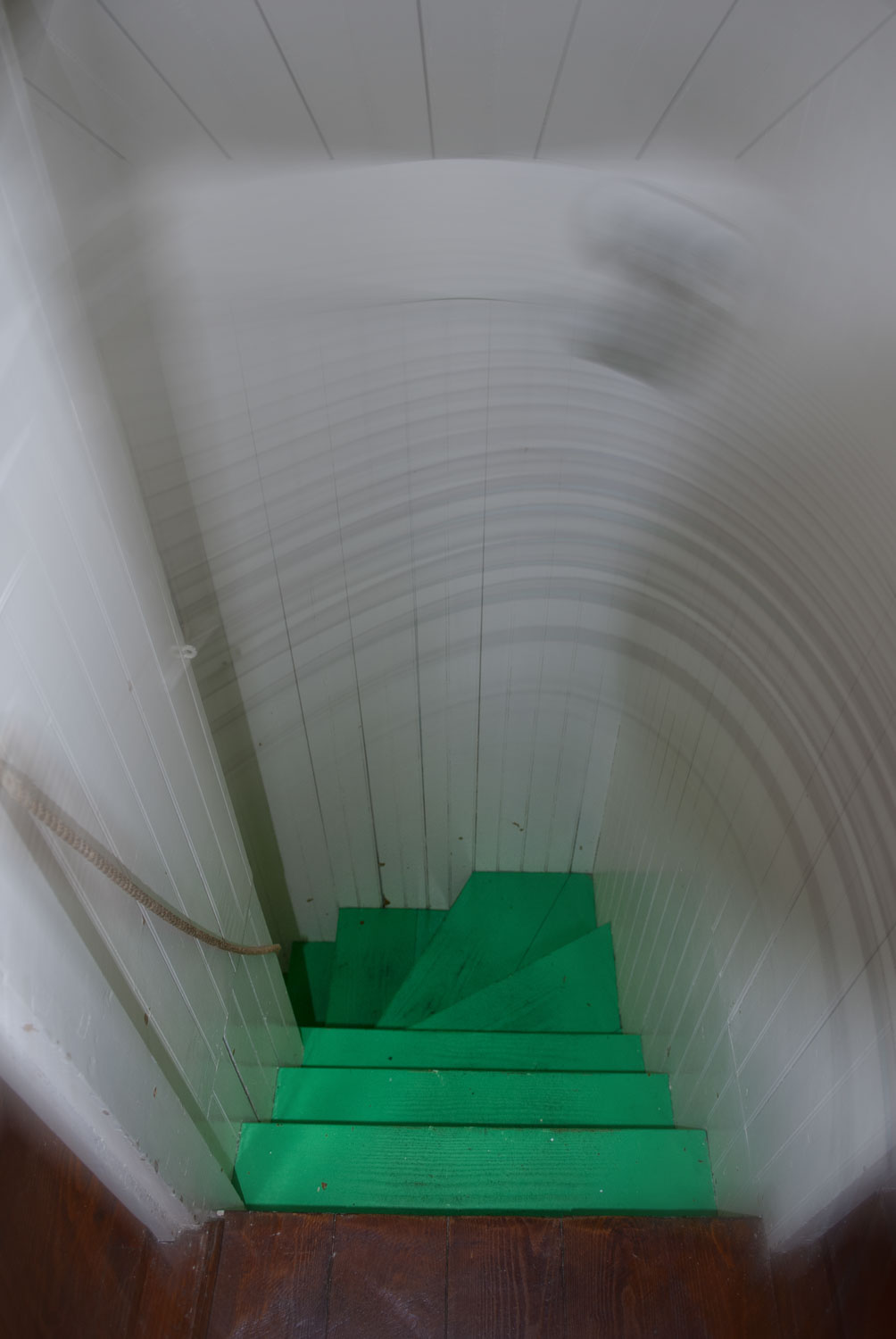 Looking down a stairwell with bright green steps