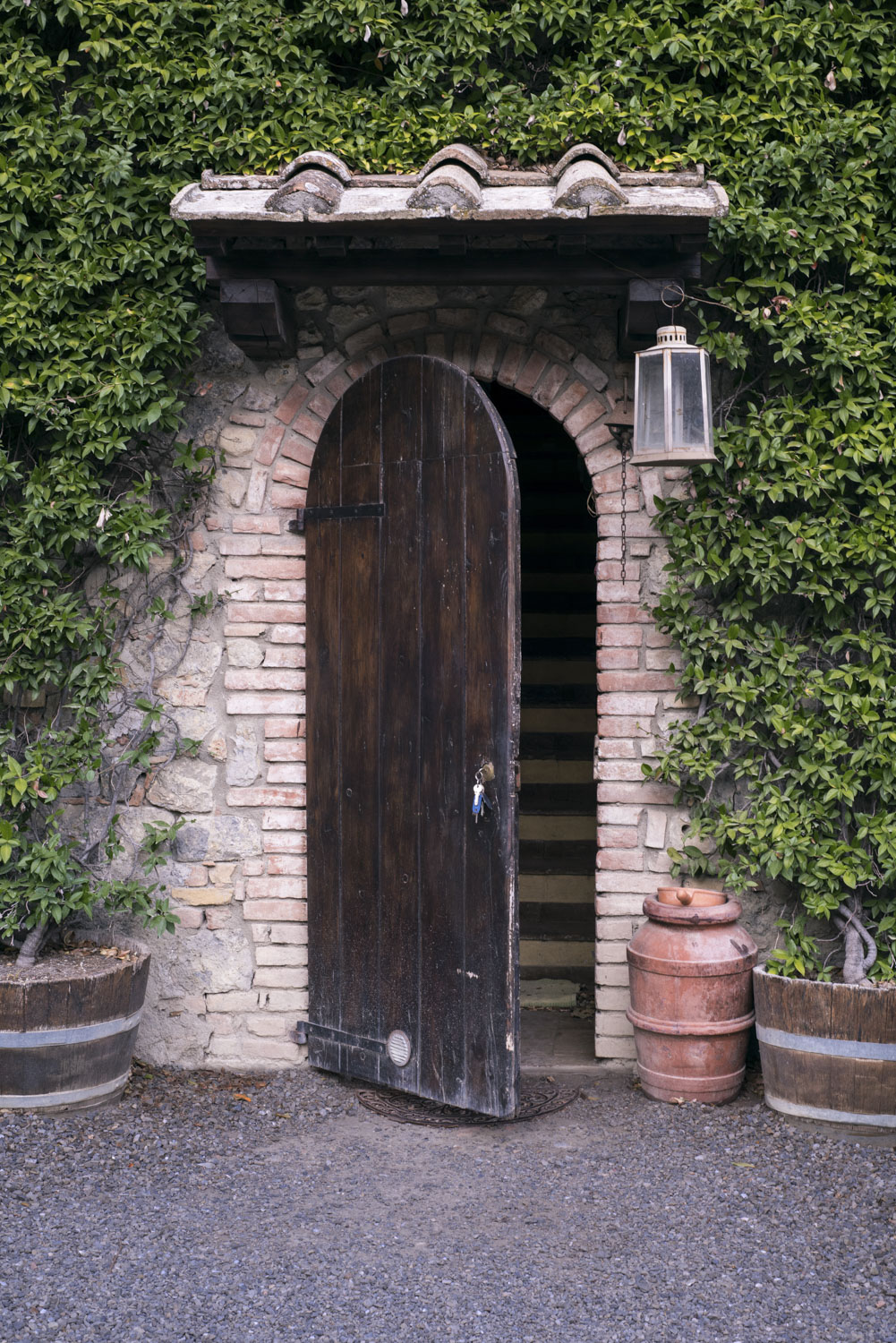 A open door with a key in the lock in Italy