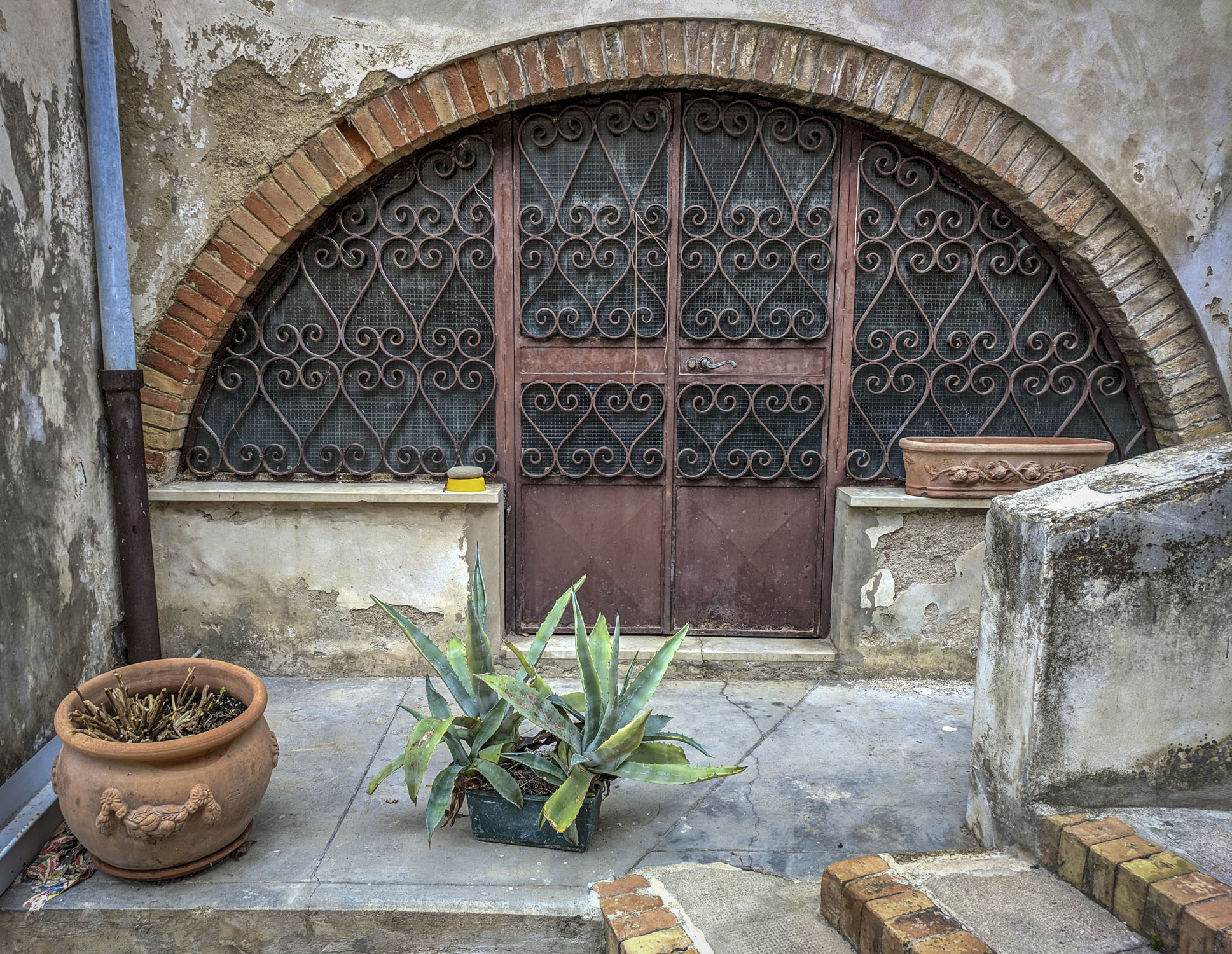 A door with decorative grating in Italy