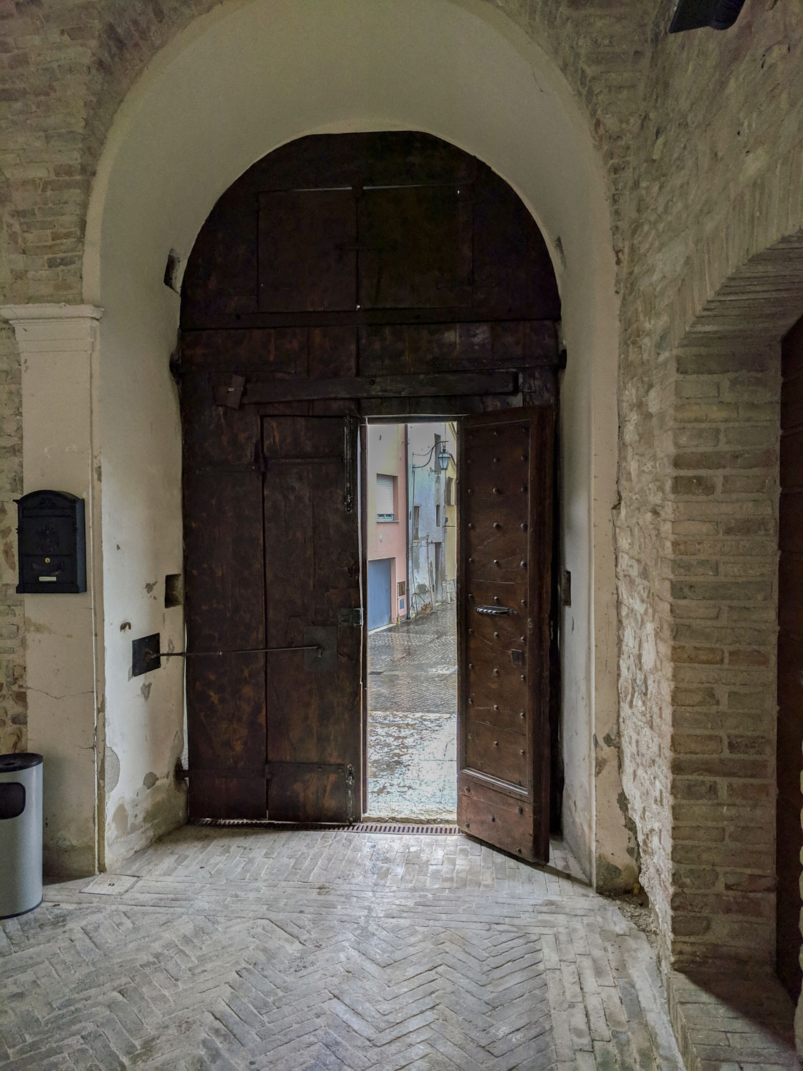 Looking out a large door in Italy