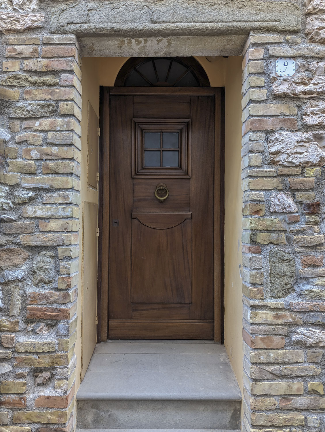 A door recessed in an entryway in Italy