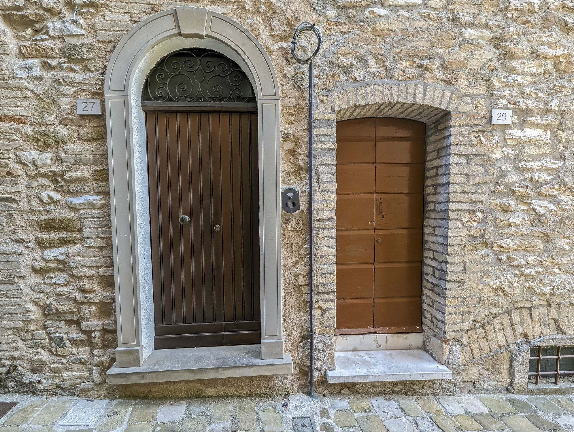 Two doors in Italy with different shapes and sizes