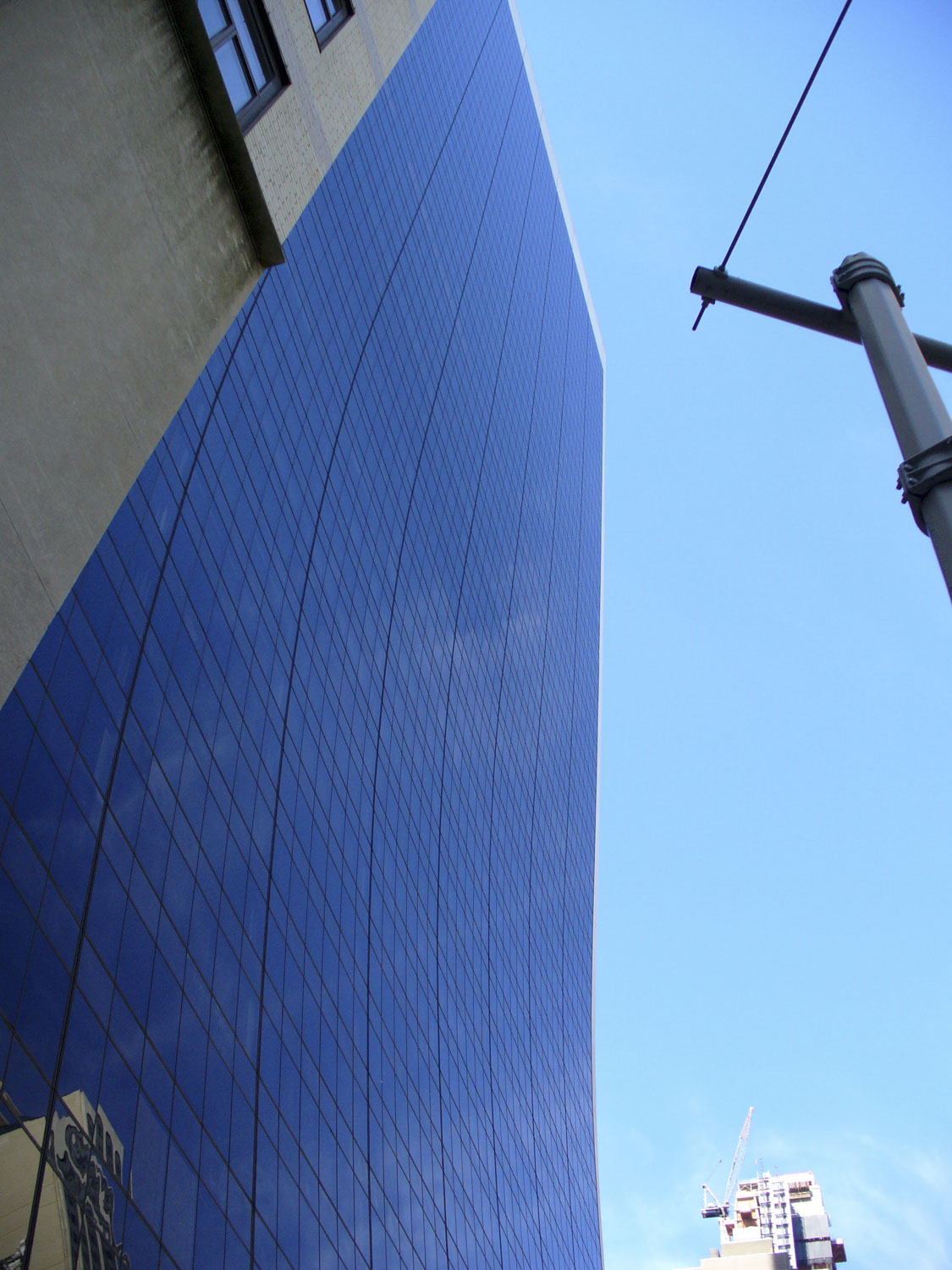 Looking up a tall mirrored building in NYC