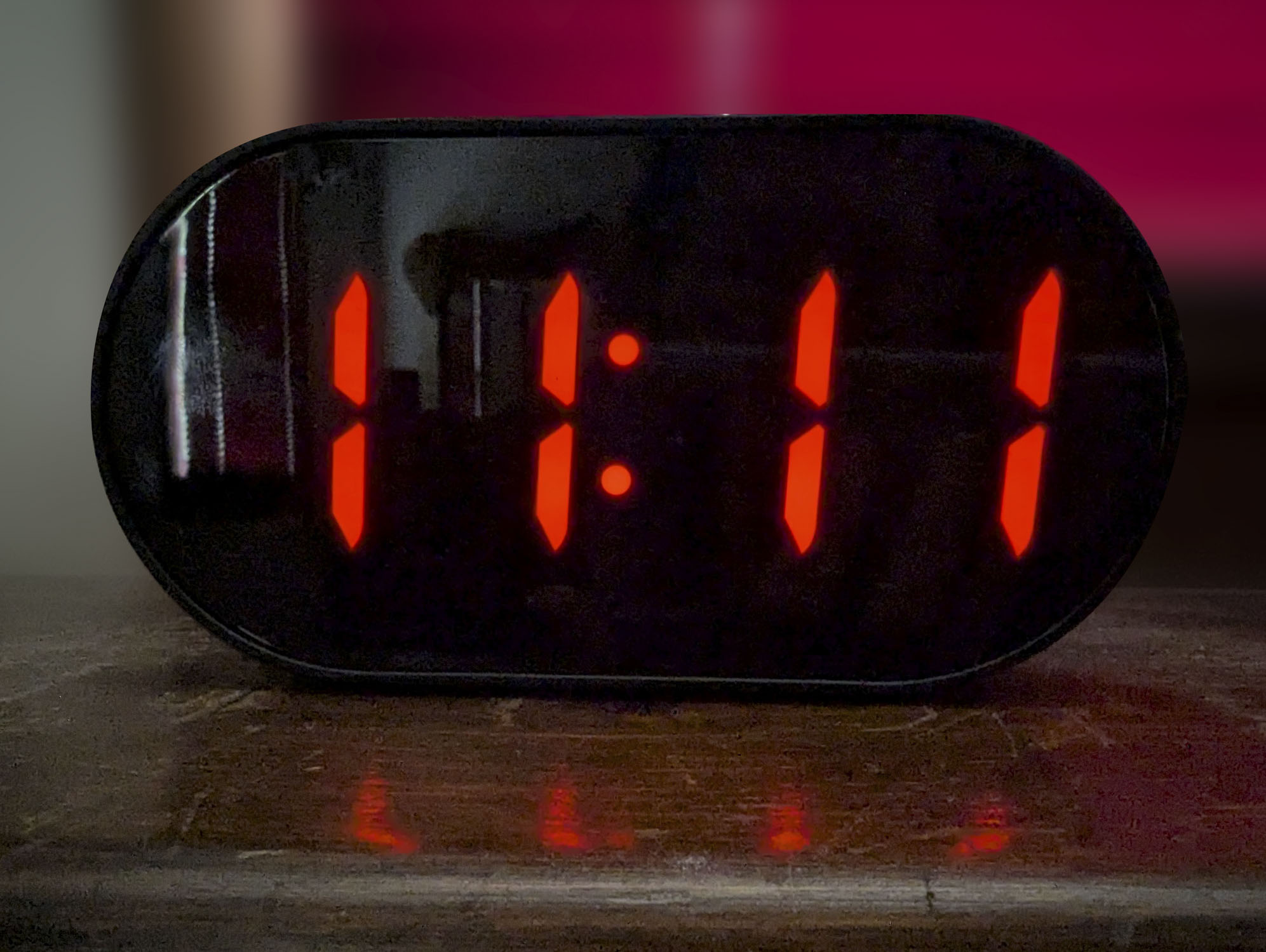 A digital clock with the time of 11 past 11.