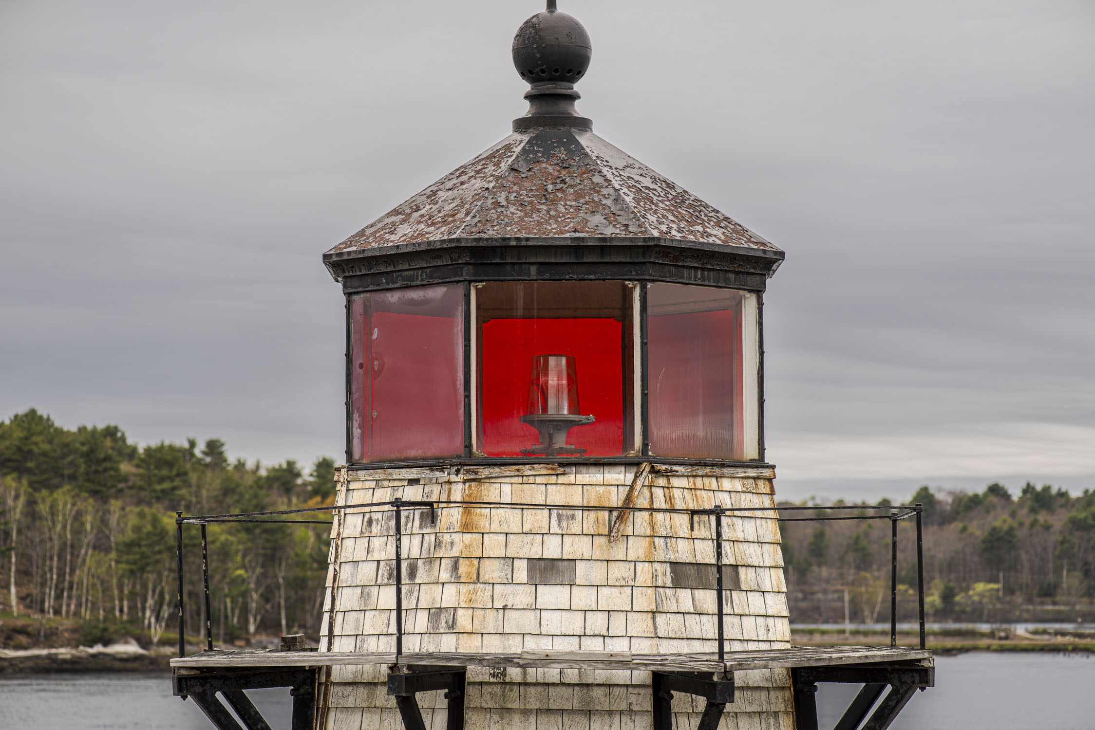 Eye level with the top of a lighthouse that has red glass