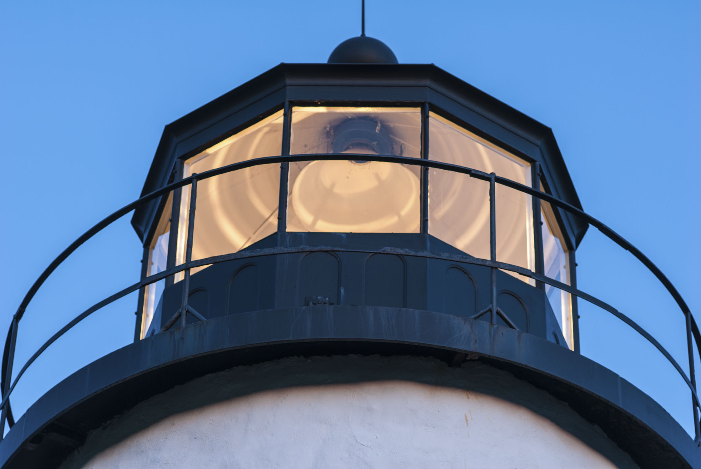 The top portion of a lighthouse that is lit