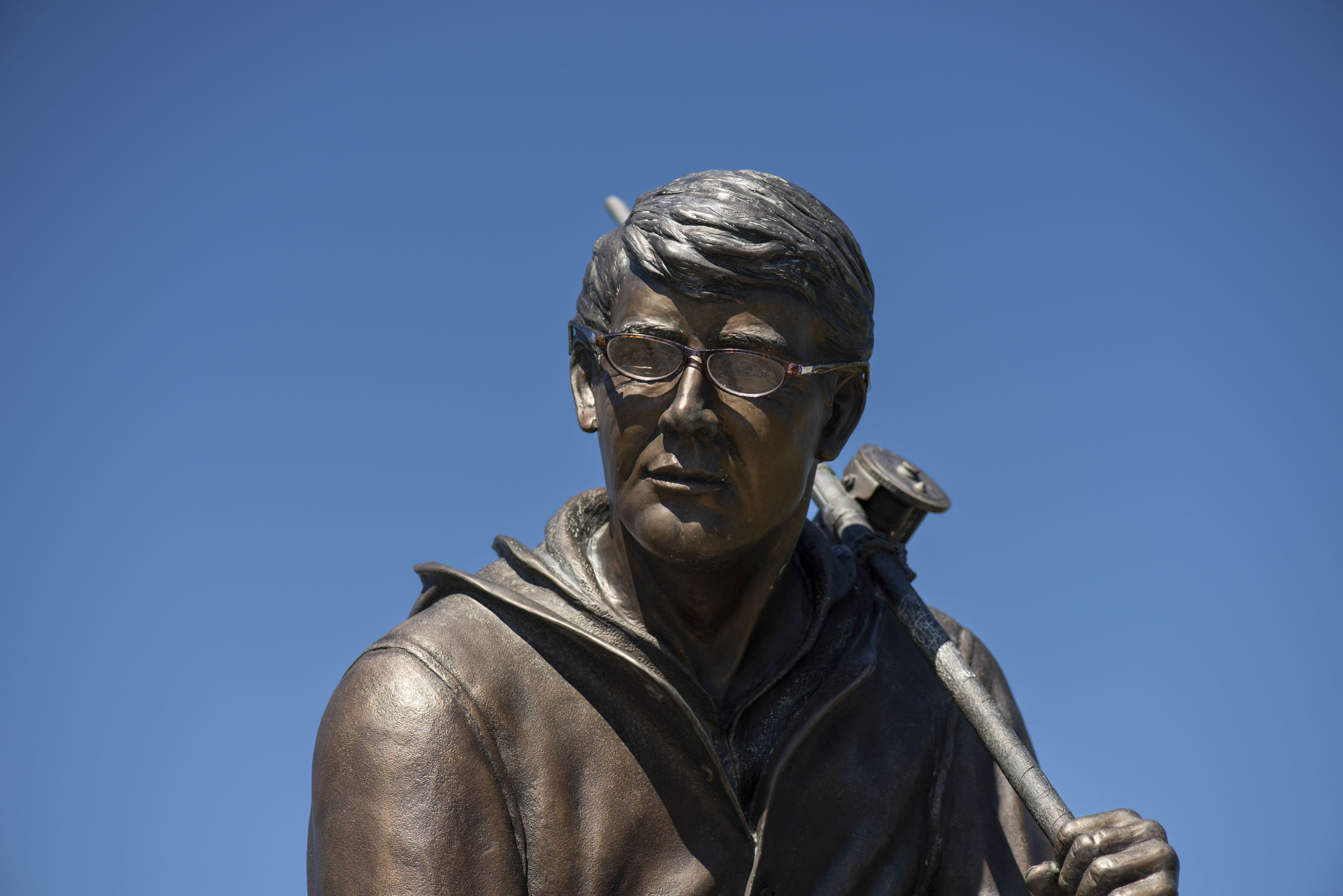A stature of a fisherman with a pair of glasses added to the face